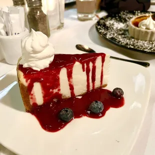 a slice of cheesecake with blueberries