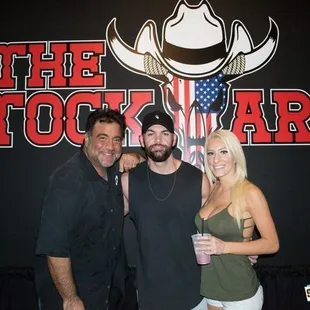 three men and a woman posing for a picture