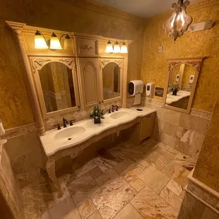 a bathroom with two sinks and a chandelier