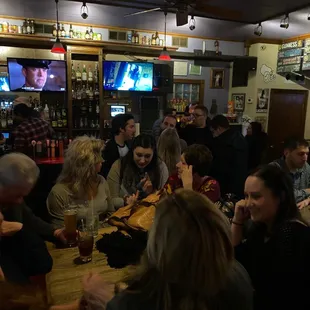 a group of people sitting at a bar