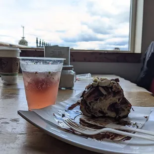 Cinnamon roll with mixed nuts + strawberry rose bellini; not-the-worst weather in the background