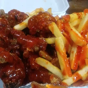 a plate of french fries and meatballs