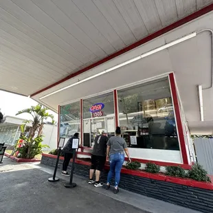 people standing outside of the store