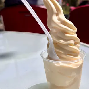 Dole Whip. Sweet and tangy pineapple flavored soft serve, piled up high in a small cup.