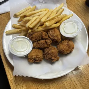 Chicken tenders and french fries with Ranch dipping sauce.