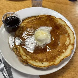 Two stack pancakes with warm syrup.