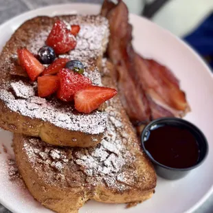 "The Frenchman"  Cinnamon toast crusted french toast, topped with fresh berries &amp; dusted with powdered sugar, served with maple pepper bacon