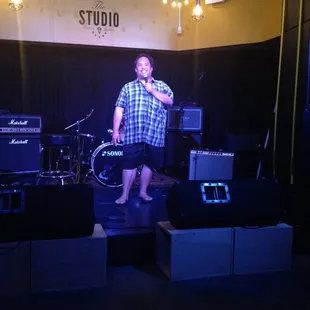 a man singing on stage