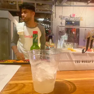 a glass of water and a bottle of beer