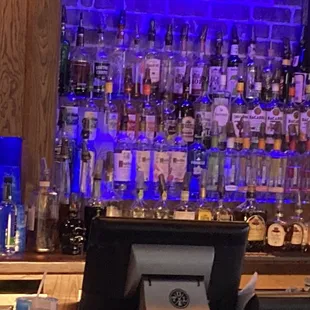 a bar counter with liquor bottles