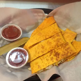 a plate of quesadillas and a pickle