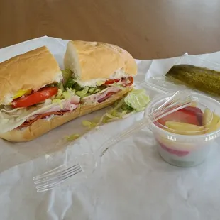 a sandwich, pickle, and pickle