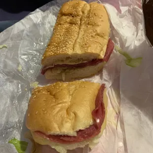 two sub sandwiches on wax paper