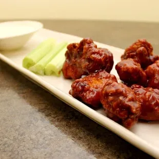 a platter of buffalo wings and celery