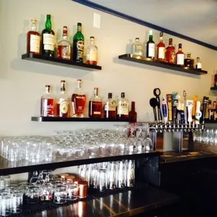 a row of liquor bottles and glasses