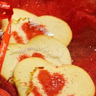 a heart - shaped cookie with red sprinkles