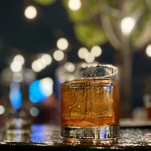a glass of whiskey on a table