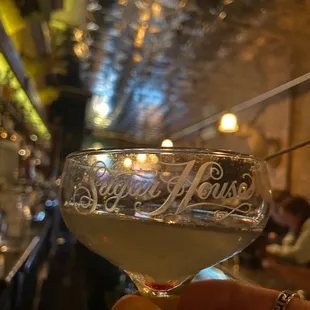 a hand holding a martini glass