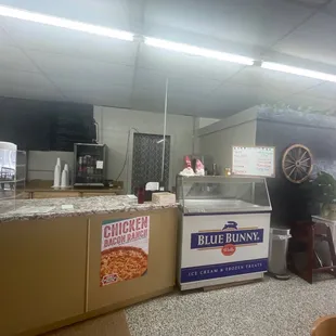a kitchen with a counter and a pizza oven