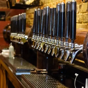 a row of beer taps