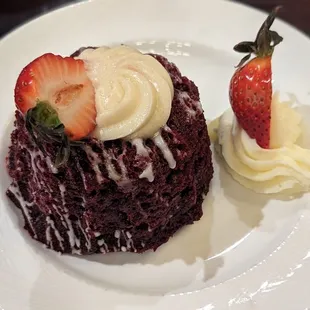 a chocolate cake with cream and strawberries