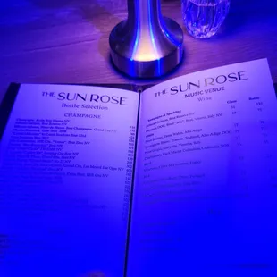 a menu and a glass of water
