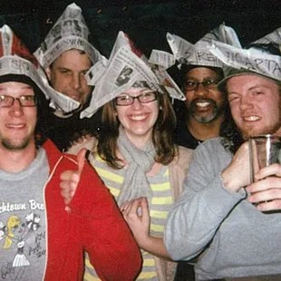a group of people wearing paper hats