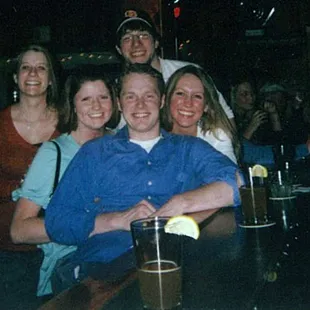 a group of people sitting at a bar
