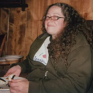 a woman sitting in a chair with a plate of food