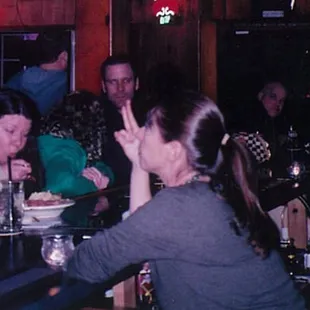 a group of people sitting at a bar