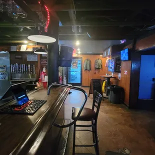 a bar with a laptop on the counter