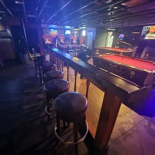 a pool table and stools