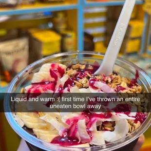 a hand holding a bowl of ice cream