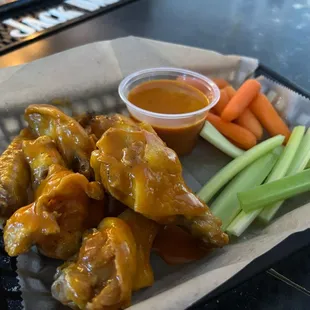 Try wings tossed in our house Sunset Gold sauce!