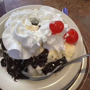 a sundae with whipped cream and cherry on top