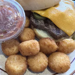 a hamburger and tater tots on a plate