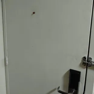 They used a dirty, disposable ear plug to cover the peep hole.