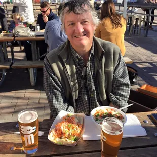 a man sitting at a table with a plate of food