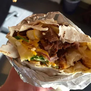 Borachito burrito - the fries are inside! So delicious. Comes with shredded beef, cilantro and sriracha sour cream. Que rico!