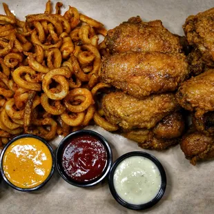 a plate of fried chicken, onion rings, and ketchup