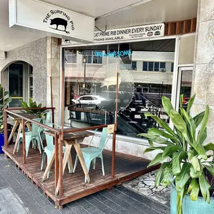 Nice outdoor shaded seating on the sidewalk.