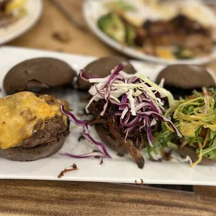 TARO BUN SLIDER TRIO | 22 -KONO'S AWARD-WINNING KALUA PORK, W/ SLAW -GUAVA BBQ BEEF W/BOURBON ONIONS &amp; CHEDDAR -CRAB CAKE W/ AIOLI