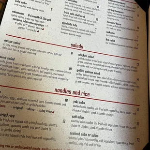 a hand holding a menu
