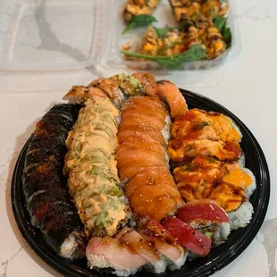 a plate of sushi and a bowl of salad