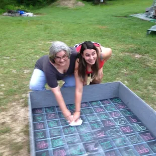 a woman and a woman cleaning a pool