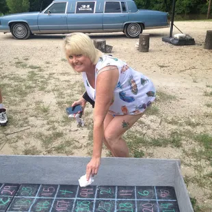 a woman playing a game of tic - tac - toe