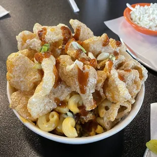 pig&apos;s mac &amp; cheese - creamy beer cheese sauce, pork belly, green onions, and cavatappi topped w/ crispy fried pork rinds and bbq sauce