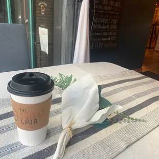 a coffee cup and napkin on a table