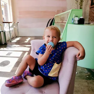 Alice enjoying her blueberry macaroon.