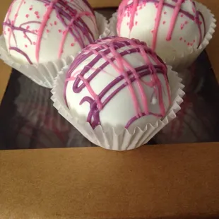 three white chocolate truffles with pink sprinkles